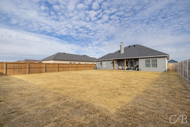 back of property with a yard, a patio, and central AC unit