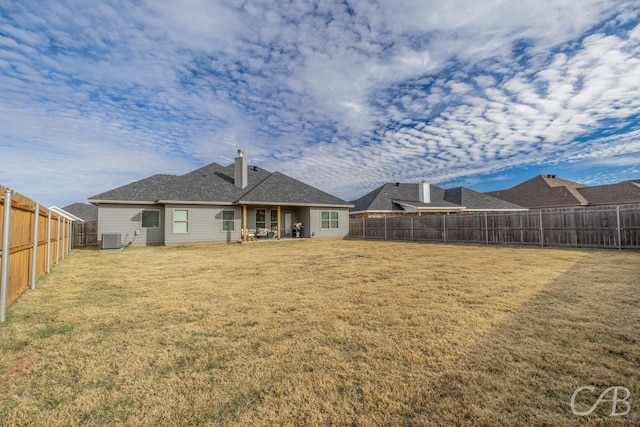 back of house with a yard and cooling unit