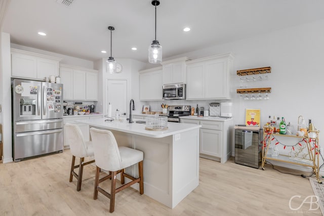 kitchen featuring white cabinets, sink, backsplash, and appliances with stainless steel finishes