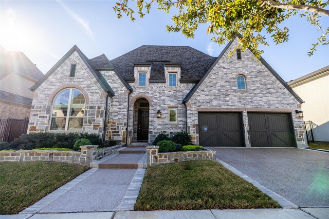 view of front of home featuring a garage and a front lawn