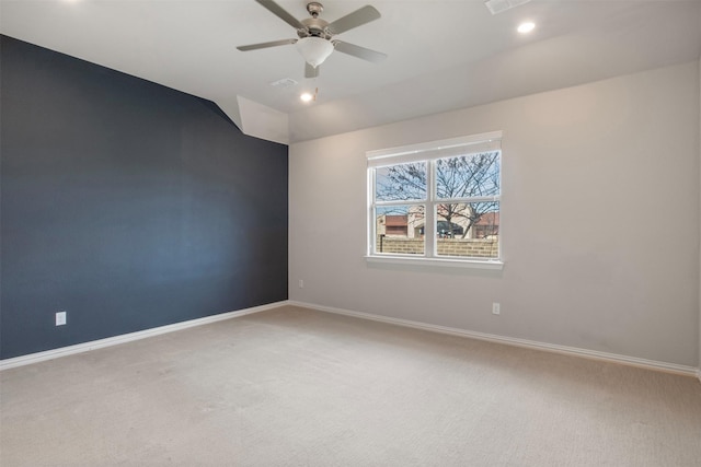 carpeted spare room featuring lofted ceiling and ceiling fan