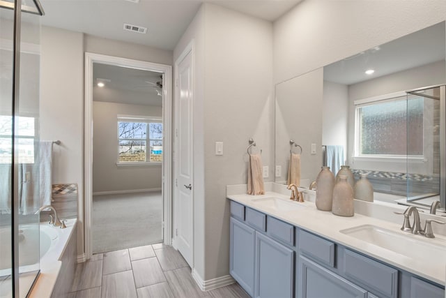 bathroom with a washtub and vanity