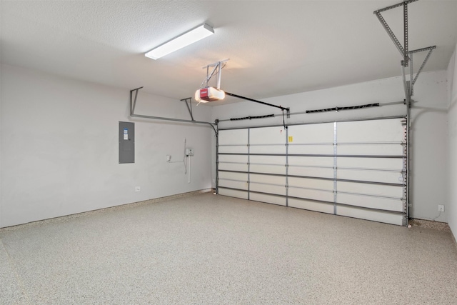 garage with a garage door opener and electric panel