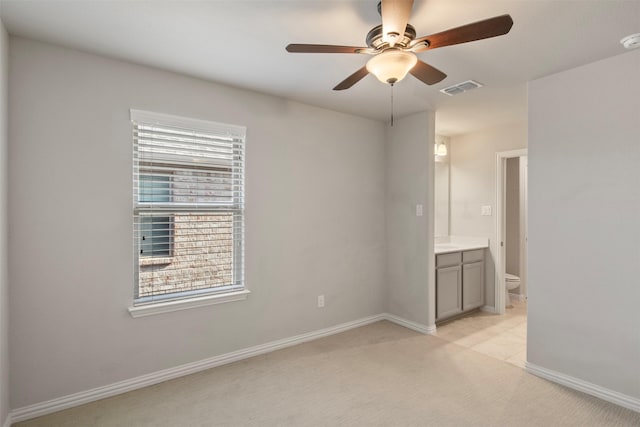 carpeted spare room with ceiling fan