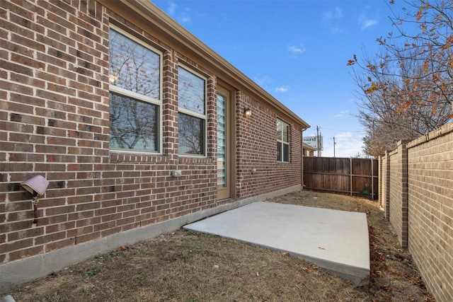 view of side of home featuring a patio area