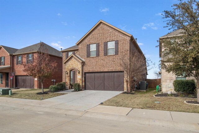 view of property with a garage, a front lawn, and central air condition unit