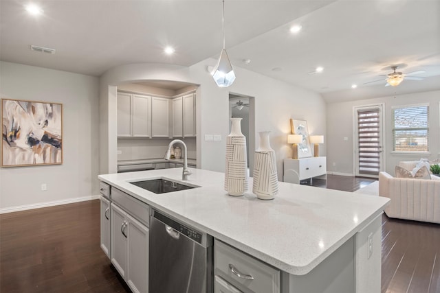 kitchen featuring hanging light fixtures, dishwasher, sink, and a kitchen island with sink