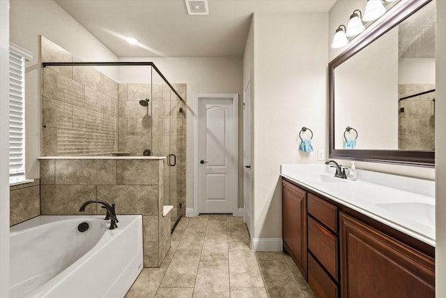 bathroom with tile patterned flooring, vanity, and plus walk in shower