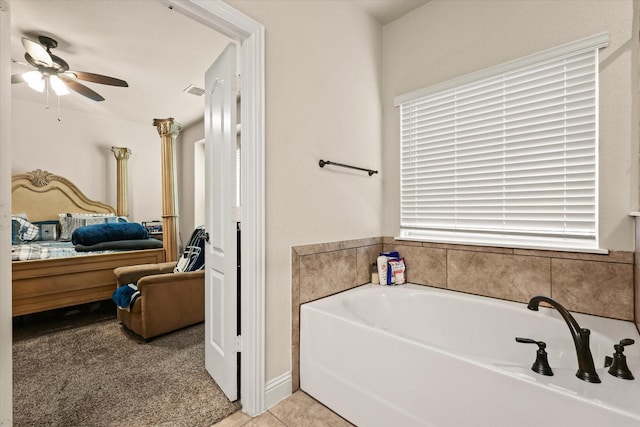 bathroom featuring a tub to relax in, ceiling fan, and tile patterned floors