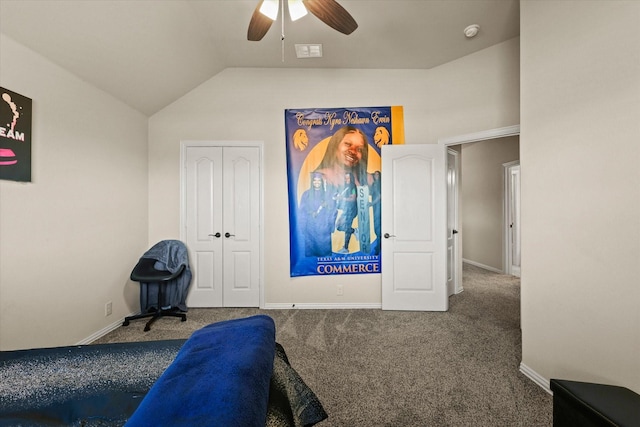 carpeted bedroom with ceiling fan, lofted ceiling, and a closet