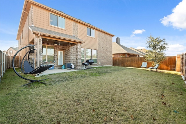 rear view of house with a yard and a patio