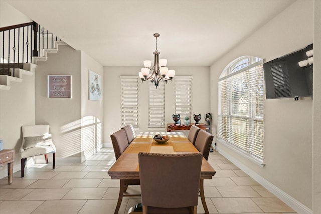 dining space featuring a notable chandelier and light tile patterned floors