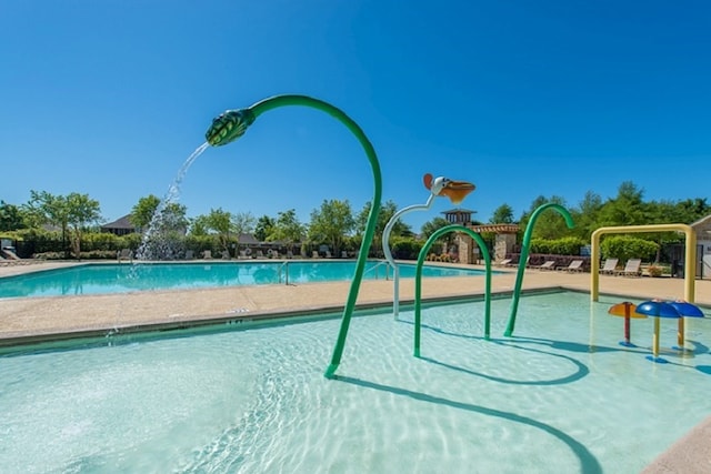 view of pool with a playground