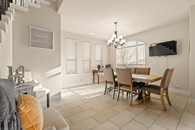 dining area featuring light tile patterned floors and a chandelier