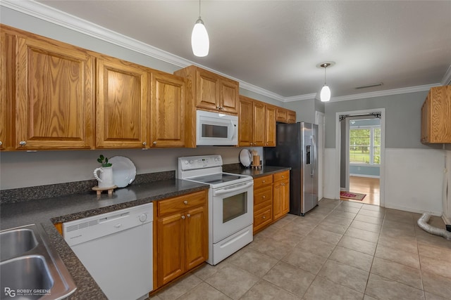 kitchen with sink, crown molding, decorative light fixtures, light tile patterned floors, and white appliances