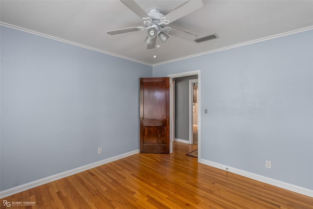 spare room featuring crown molding, ceiling fan, and hardwood / wood-style floors