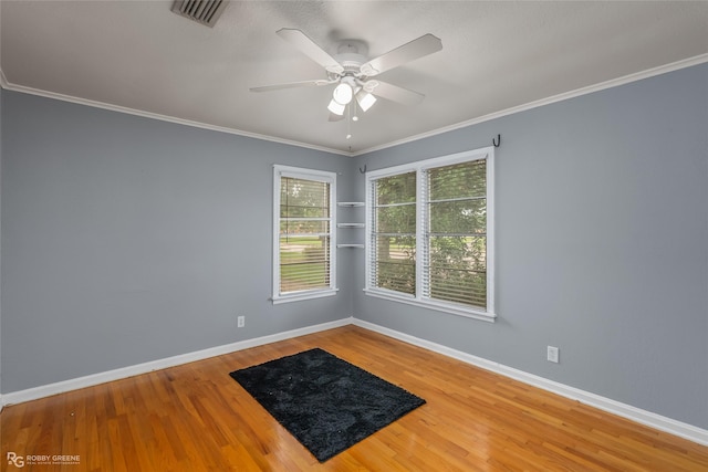 spare room with ornamental molding, wood-type flooring, and ceiling fan