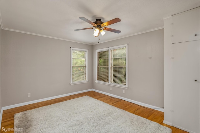 spare room featuring crown molding, ceiling fan, and hardwood / wood-style floors