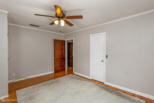 spare room with ceiling fan, ornamental molding, and hardwood / wood-style floors