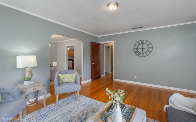 living room with hardwood / wood-style flooring and ornamental molding