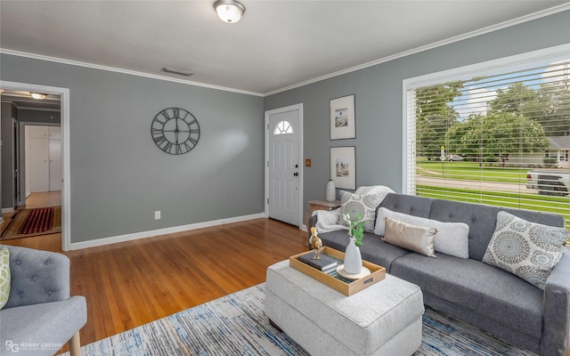 living room with ornamental molding and hardwood / wood-style floors