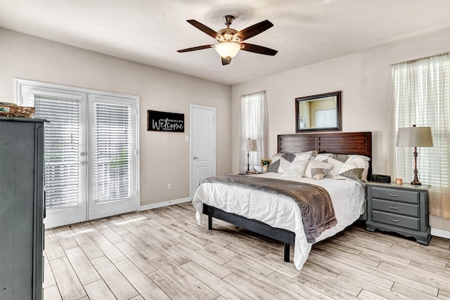 bedroom with ceiling fan, access to exterior, light wood-type flooring, and french doors