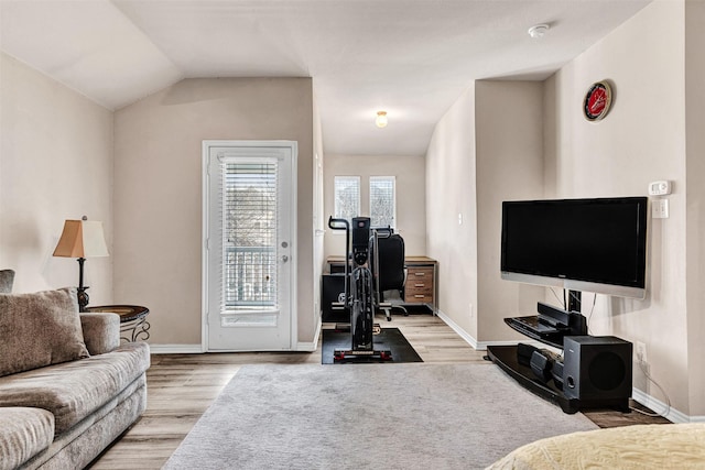 living room with light hardwood / wood-style floors and lofted ceiling