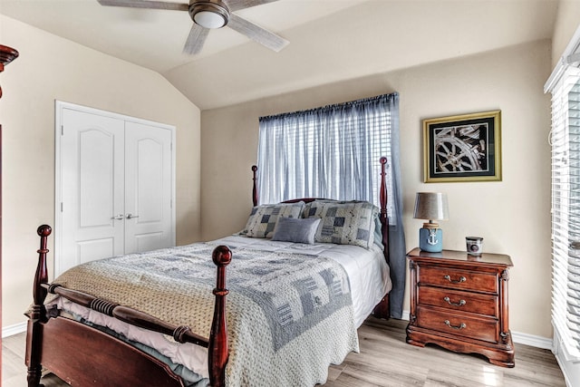 bedroom with light wood-type flooring, a closet, and ceiling fan