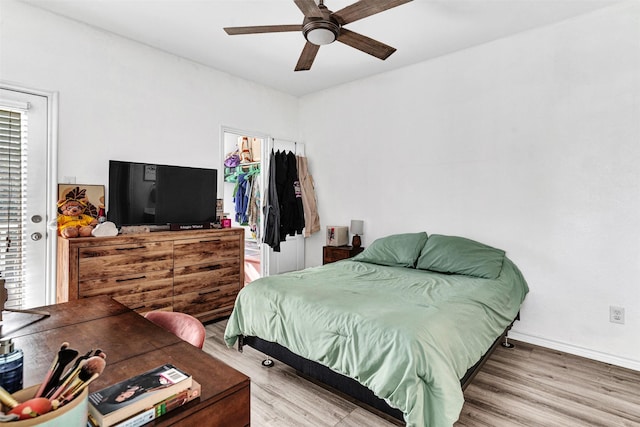 bedroom featuring ceiling fan, a closet, and wood-type flooring