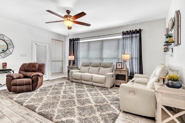 living room with ceiling fan and hardwood / wood-style floors