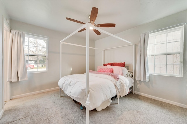 bedroom with ceiling fan and light carpet