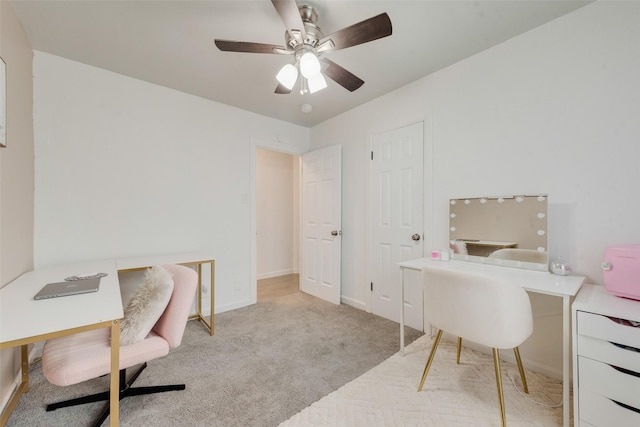 carpeted home office with ceiling fan