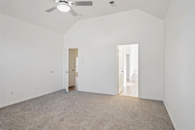 spare room with light carpet, ceiling fan, and high vaulted ceiling