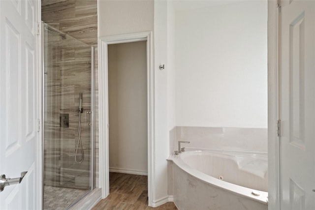 bathroom with separate shower and tub and hardwood / wood-style flooring