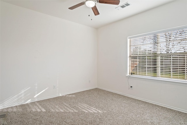 carpeted spare room featuring ceiling fan