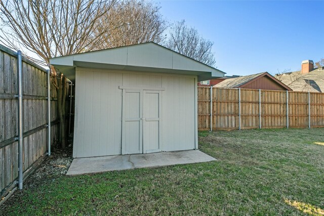 view of outbuilding featuring a lawn