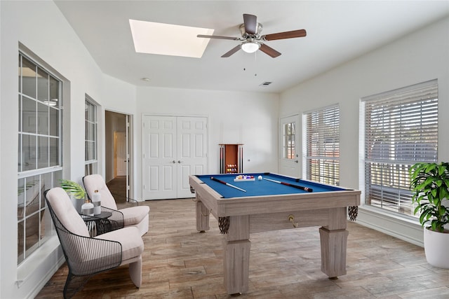 game room with a skylight, ceiling fan, and pool table