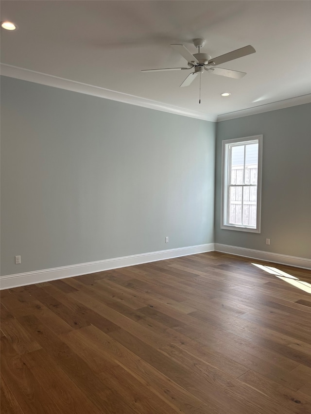 empty room with a ceiling fan, baseboards, recessed lighting, dark wood-type flooring, and crown molding