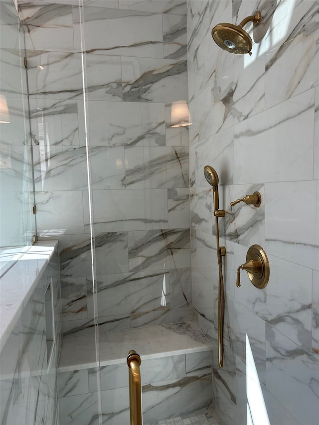 full bathroom featuring a marble finish shower