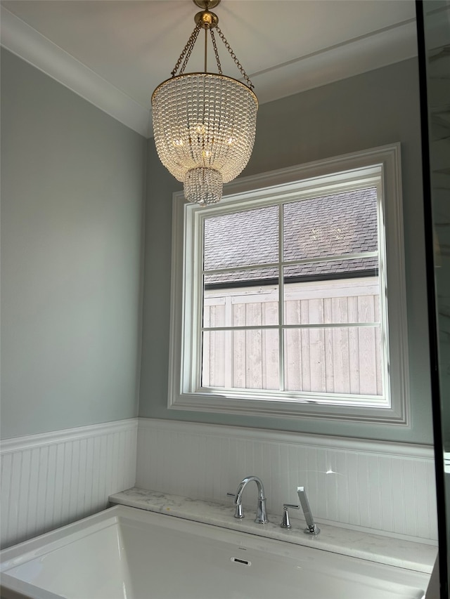 bathroom with a notable chandelier and wainscoting