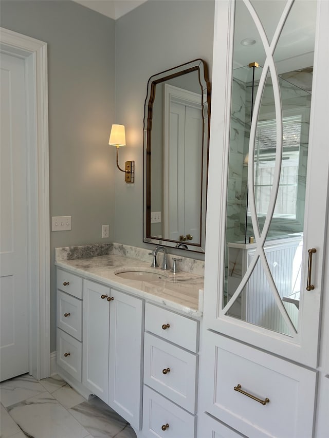 bathroom with marble finish floor and vanity