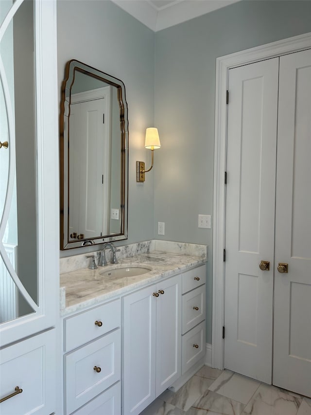 bathroom featuring marble finish floor and vanity