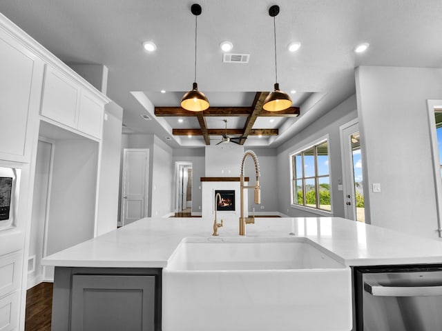 170 Fan Mill Trl, Weatherford, TX 76085 - kitchen with stainless steel dishwasher, visible vents, a warm lit fireplace, a sink, and coffered ceiling