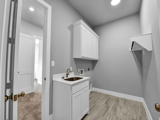 170 Fan Mill Trl, Weatherford, TX 76085 - laundry room with baseboards, hookup for a washing machine, electric dryer hookup, a sink, and cabinet space