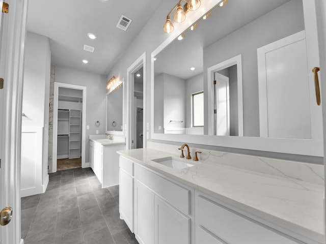 170 Fan Mill Trl, Weatherford, TX 76085 - full bathroom featuring visible vents, two vanities, a sink, and a spacious closet