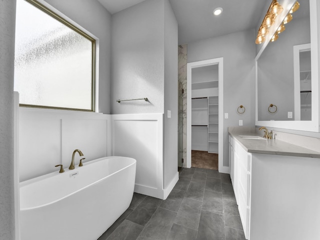 170 Fan Mill Trl, Weatherford, TX 76085 - full bathroom with recessed lighting, a freestanding tub, a spacious closet, and vanity