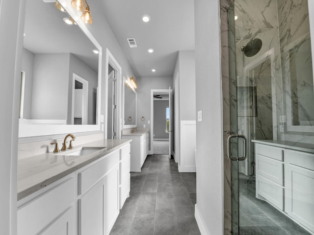 170 Fan Mill Trl, Weatherford, TX 76085 - bathroom with recessed lighting, a marble finish shower, a sink, and two vanities