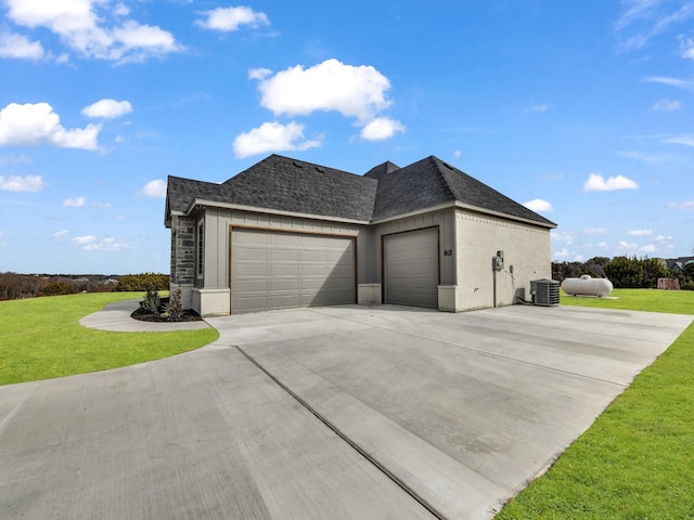 view of home's exterior with central air condition unit, a yard, and a garage