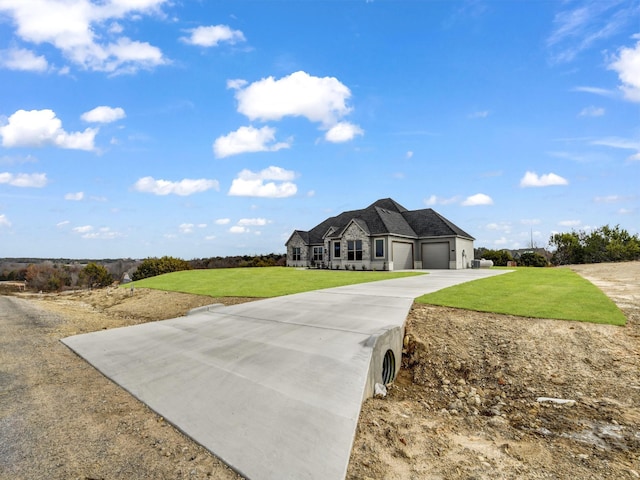 view of front of home featuring a garage and a front lawn