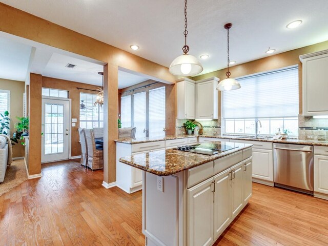 kitchen featuring sink, white cabinets, dishwasher, and a wealth of natural light